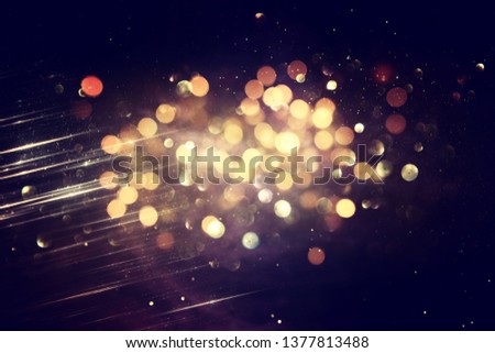 glitter vintage lights background. black and gold. de-focused