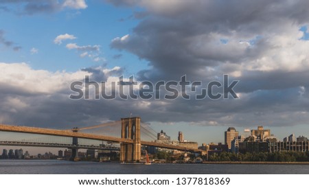 Brooklyn and Manhattan bridge over East River at dusk with skyline of Brooklyn, viewed from lower Manhattan, New York, USA