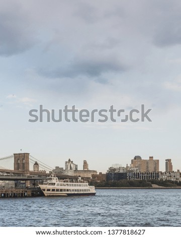 Brooklyn and bridge over East River at dusk with skyline of Brooklyn, viewed from lower Manhattan, New York, USA