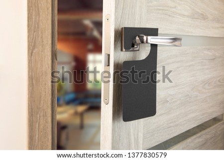 A door handle with blank paper hanger