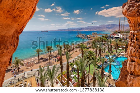Summer serene day on central public beach of Eilat - famous tourist resort and recreational city in the Middle East and Israel Royalty-Free Stock Photo #1377838136