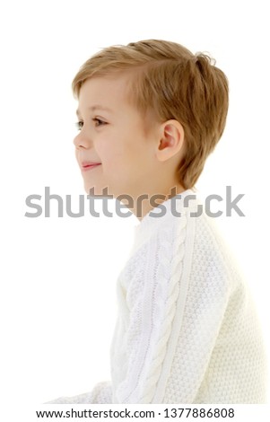 Portrait of a beautiful little boy close-up in the studio on a white background. Concept Happy childhood, family and people. Isolated.