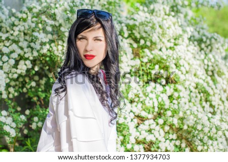  Romantic woman at spring blossom garden. Concept of woman and tenderness, modern beauty or femininity