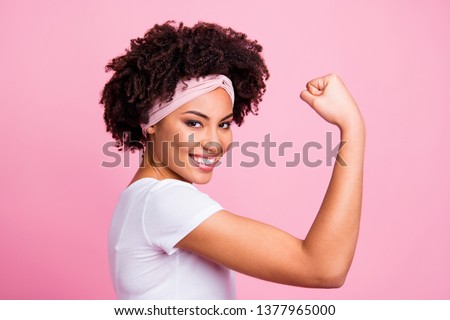 Close-up profile side view portrait of her she nice-looking attractive charming cute lovely powerful cheerful cheery wavy-haired girl showing muscles isolated over pink pastel background Royalty-Free Stock Photo #1377965000