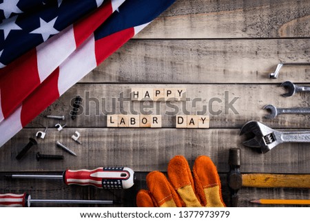 Labor Day, USA America flag with many handy tools on wooden background texture.