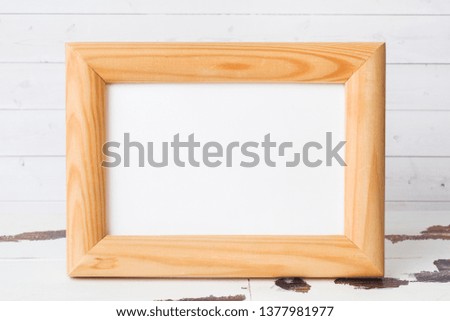 Wooden blank picture frame on white background