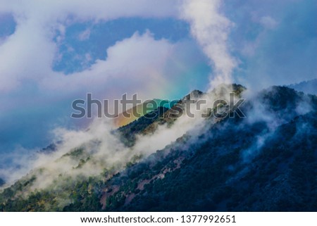 Right Before Mount Olympus in Troodos Mountains Cyprus, amazing cloudy mountain peak with a rainbow, before storm, unique photo 