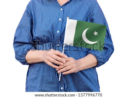 Pakistan flag. Close up of woman's hands holding a national flag of Pakistan isolated on white background.