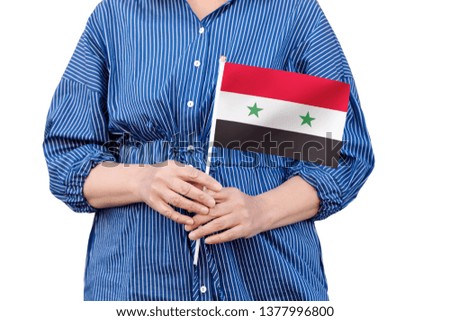 Syria flag. Close up of woman's hands holding a national flag of Syria isolated on white background.