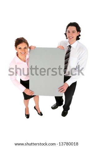 Business couple holding blank poster board