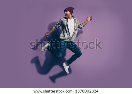 Full length size body side profile photo of cheerful handsome screaming in jeans denim clothes modern star eyewear millennial isolated violet background