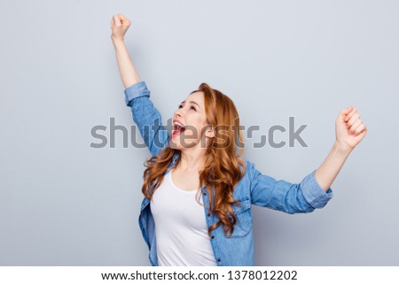 Close up photo beautiful amazing she her foxy curly lady arms hands raised yell excited football cheerleader goal unbelievable unexpected wear casual blue jeans denim shirt isolated grey background