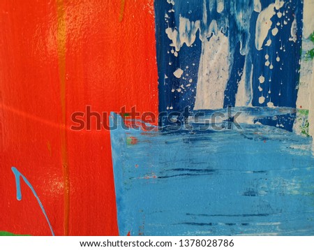 Colourful painting on wall with red, light blue and dark blue in grunge style. Acrylic Cement using as background or artwork. 
