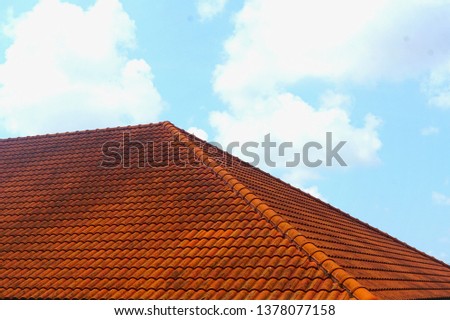 Red tile roof with beautiful ky background