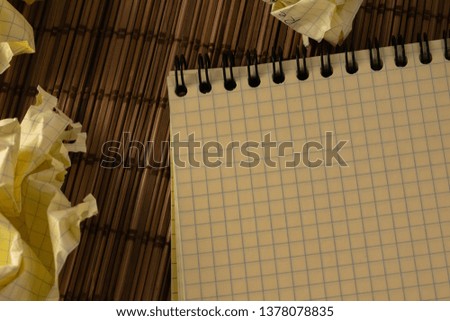Close up yellow notebook with paper