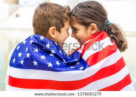Two children wrapped in the American flag