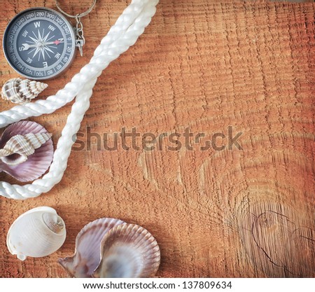 compass and rope on a wooden table
