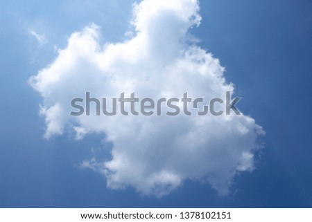 White clouds on blue sky .