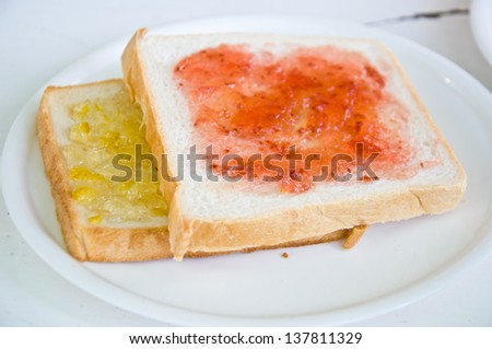 bread with strawberry jam for breakfast meal