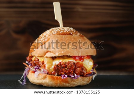fresh tasty beef burger with cheese on wood background.