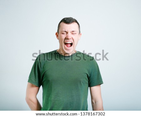 portrait of a successful man shouting, studio photo over background