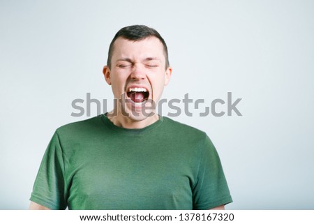 portrait of a successful man shouting, studio photo over background