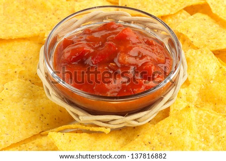 bowl of hot sauce on background of nachos