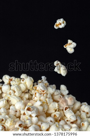 Popcorn, pop corn, close of pop corn freshly made macro shot showing texture and pattern with black background for text copy