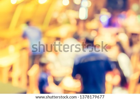 Vintage tone image of blur restaurant or coffee shop with people on night time with bokeh for background usage.
