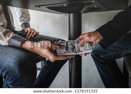 Dishonest cheating in business illegal money, Businessman receive bribe money under table to business people to give success the deal contract of investment, Bribery and corruption concept. Royalty-Free Stock Photo #1378191335