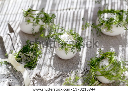 chicken eggs with wreaths of blooming coriander.