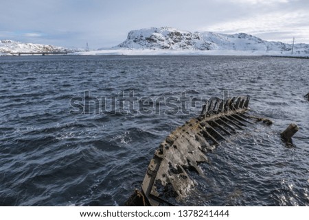 Shipwreck old in the sea After the war background iceberg Russia MURMANSK
