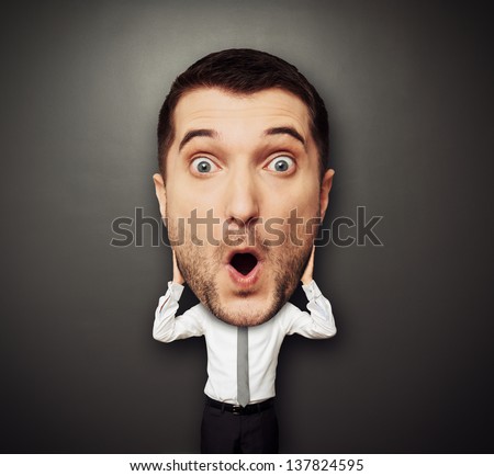 funny picture of amazed man with big head over dark background Royalty-Free Stock Photo #137824595
