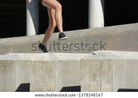 Woman doing sports, jumping obstacles, without her face being seen
