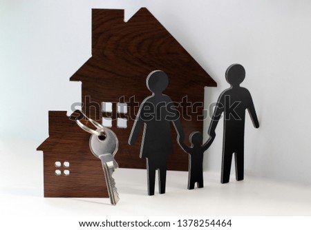 Silhouettes of people (family) and a new house with keys
