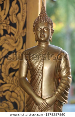 golden Buddha statue with green background