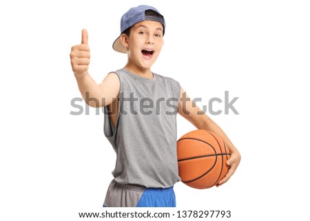 Cool teenage boy with a basketball showing thumbs up isolated on white background