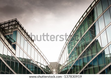 Architectural detail of a modern building with dark sky on background