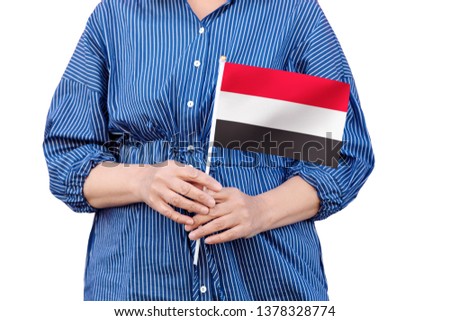 Yemen flag. Close up of woman's hands holding a national flag of Yemen isolated on white background.