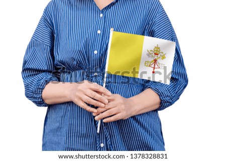 Vatican City flag. Close up of woman's hands holding a national flag of Vatican City isolated on white background.