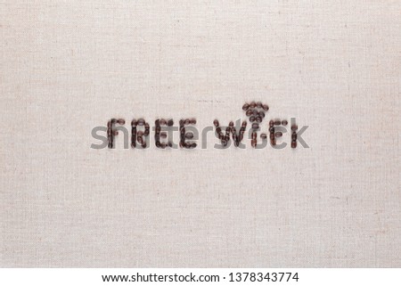Free wifi sign made from coffee beans on linea background, shot top view, aligned center.