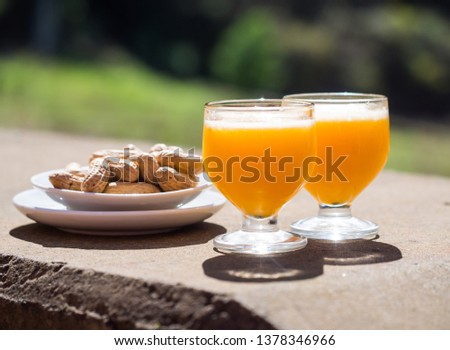 Poncha, a traditional alcoholic drink from the island of Madeira, Portugal, made with aguardente de cana and fresh passion fruit. Served along with peanuts. Royalty-Free Stock Photo #1378346966