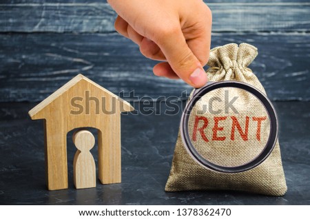 A bag with money and the word Rent and a house with a tenant inside. The accumulation of money to pay rental housing. Rental apartment. Saving money. Renting a house. Renter