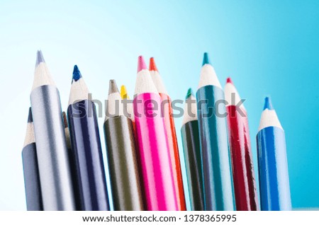 close-up image of colourful pencils over beautiful reverberation gradient background