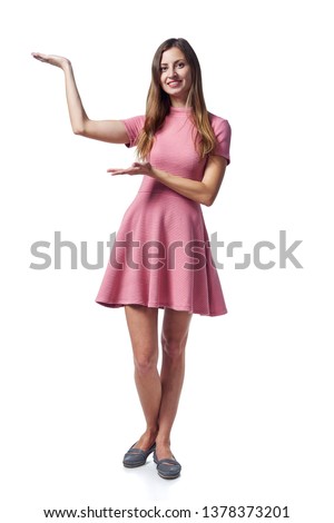 Full length of young woman in pink dress showing blank copy space over white background