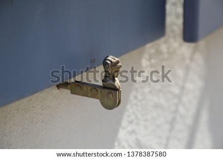 Antique metal window shutter holder in Germany