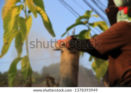 Construction workers by using a cement cutting device at a monolith with blurred. 