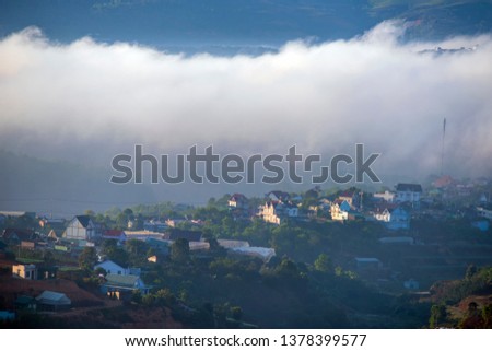 beautiful fog cover village in valley with colorful houses as islands in the mist