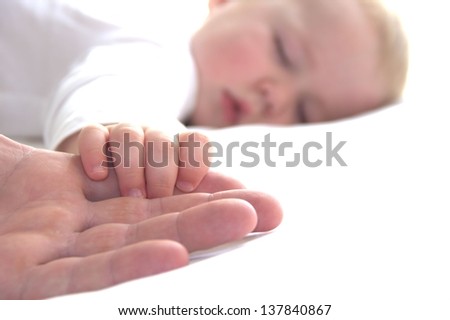 Sleeping boy is holding father's hand Royalty-Free Stock Photo #137840867