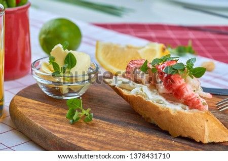 Delicious snacks on toast with shrimp, fish and avacado